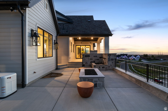 115 East Hidden Ridge Lane, Unit 42 Mapleton, UT 84664 - Photo 84 of 103 Spacious outdoor patio featuring a built-in fire pit, stone accent wall with water feature, and a black metal railing