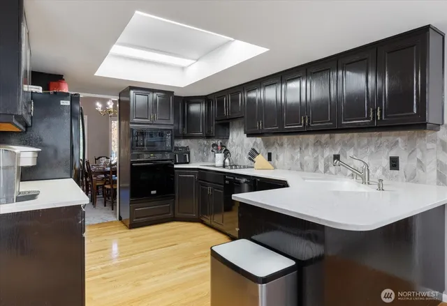a kitchen with stainless steel appliances granite countertop wooden cabinets a sink and dishwasher