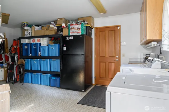 a living room with furniture a flat screen tv and floor to ceiling window