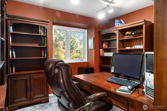a bedroom with a bed and a flat tv screen on wall
