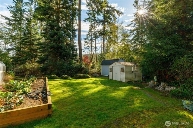 a view of a house with backyard and sitting area