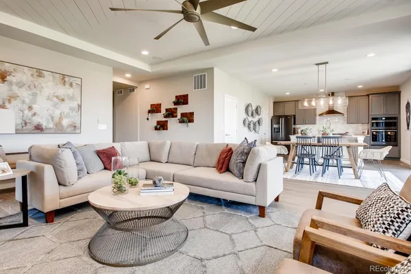 a living room with furniture and kitchen view