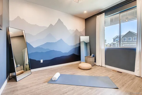 a bedroom with a bed and a large window