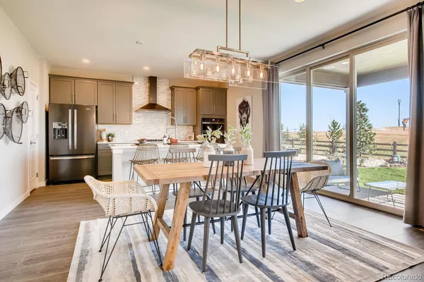 a view of a dining room with furniture large window and wooden floor