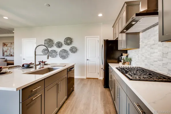 a kitchen with a sink stove and cabinets