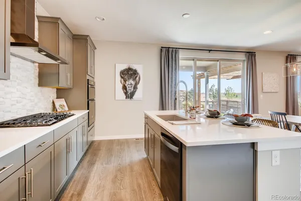 a kitchen with a sink stove and cabinets
