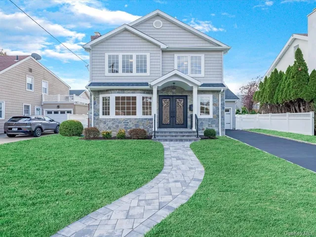 a front view of a house with a yard