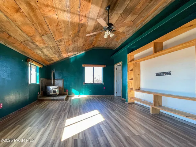 a view of a hallway with wooden floor and a fireplace
