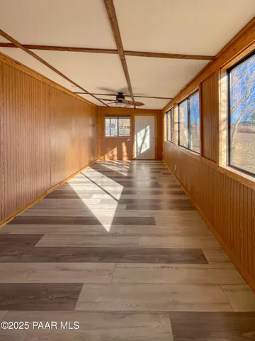 a view of a room with wooden floor and bench
