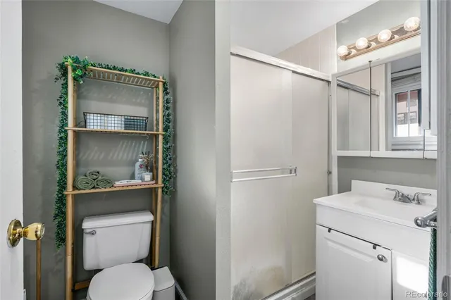 a bathroom with a toilet sink and shower