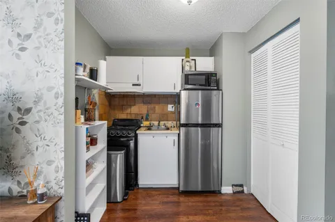 a kitchen with stainless steel appliances a refrigerator and a stove top oven