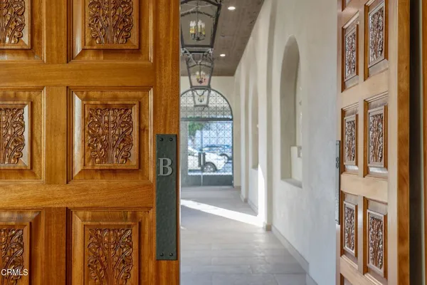 a living room with furniture and a large mirror