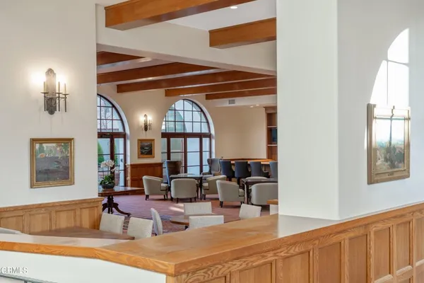a living room with furniture a fireplace and a large window