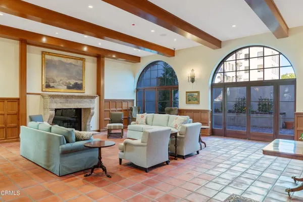 a living room with furniture a large window and chairs