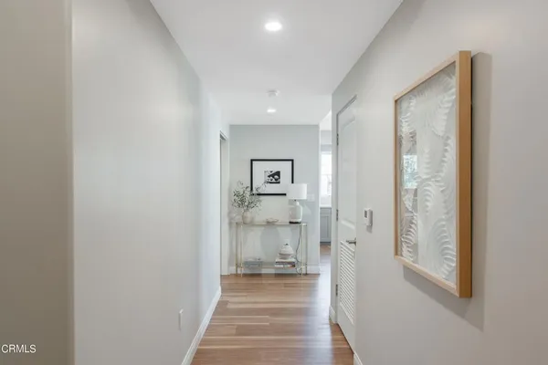 a living room with furniture dining table and wooden floor