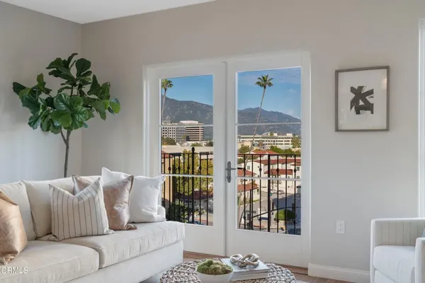 a living room with fireplace furniture and a potted plant