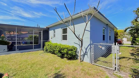 a kitchen with a sink cabinets appliances and a window