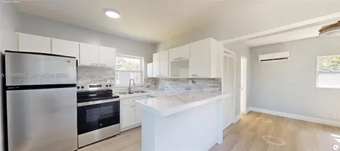 a kitchen with a refrigerator and a sink