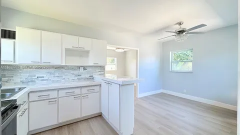 an empty room with wooden floor and a window