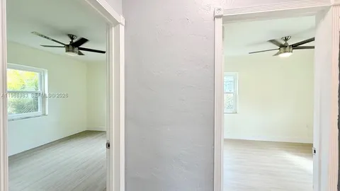 a view of a livingroom with a window and wooden floor