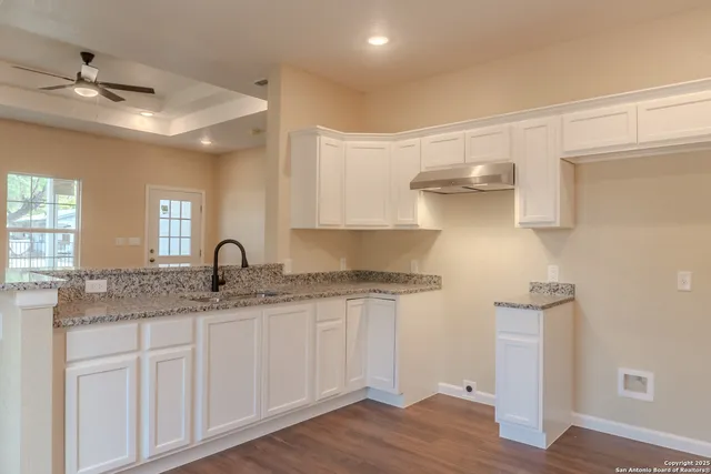 a kitchen with stainless steel appliances granite countertop a sink and cabinets