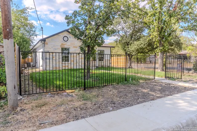 a view of a house with a small yard and plants