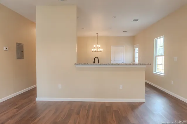 a view of kitchen with wooden floor and window