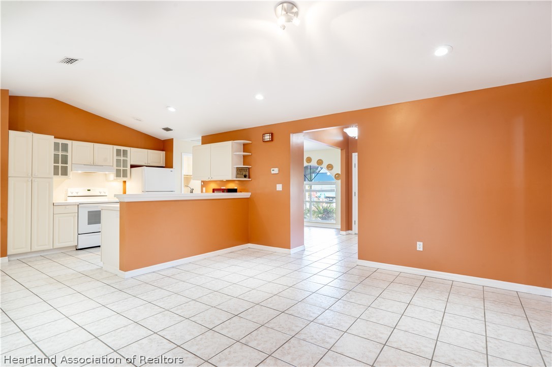 309 Lark Terrace Sebring, FL 33872 - Photo 11 of 32 a kitchen with stainless steel appliances cabinets and wooden floor