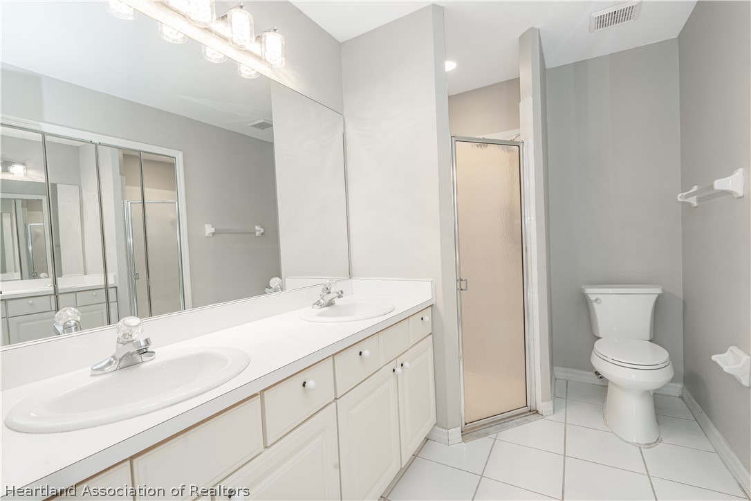 309 Lark Terrace Sebring, FL 33872 - Photo 15 of 32 a bathroom with a granite countertop sink toilet and mirror