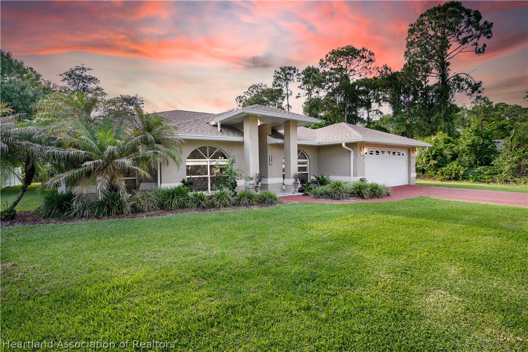 309 Lark Terrace Sebring, FL 33872 - Photo 2 of 32 a front view of a house with a yard