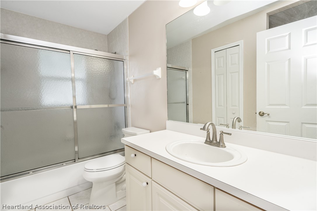 309 Lark Terrace Sebring, FL 33872 - Photo 21 of 32 a bathroom with a sink toilet and shower