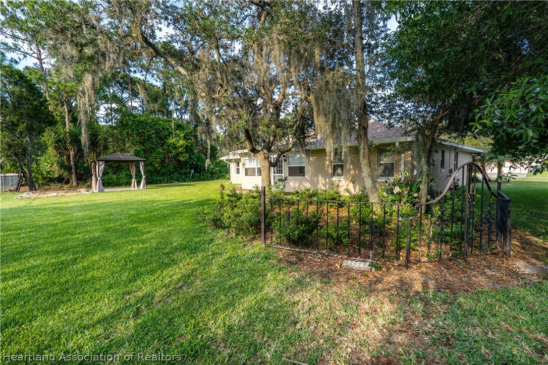 309 Lark Terrace Sebring, FL 33872 - Photo 25 of 32 a view of a house with a tree in a yard