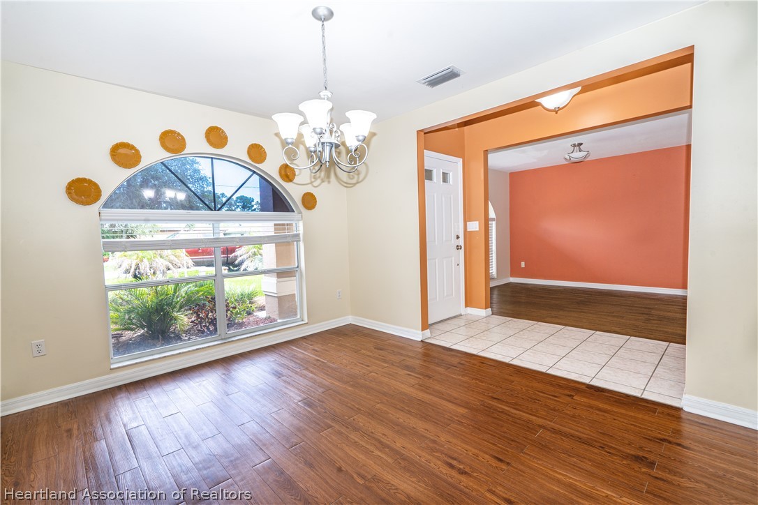 309 Lark Terrace Sebring, FL 33872 - Photo 3 of 32 a view of an entryway with wooden floor
