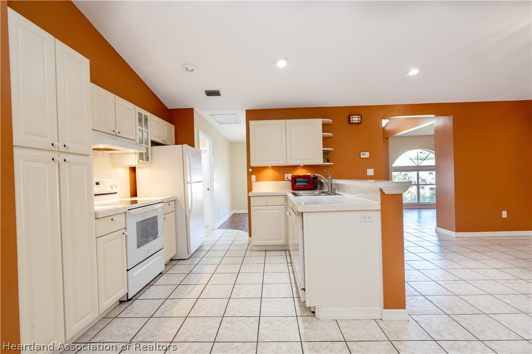309 Lark Terrace Sebring, FL 33872 - Photo 9 of 32 a kitchen with a sink cabinets and appliances