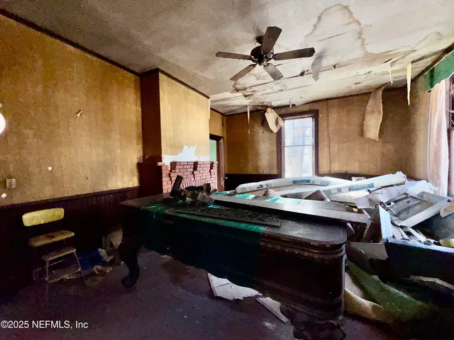 a room with furniture pool table ceiling fan and a rug