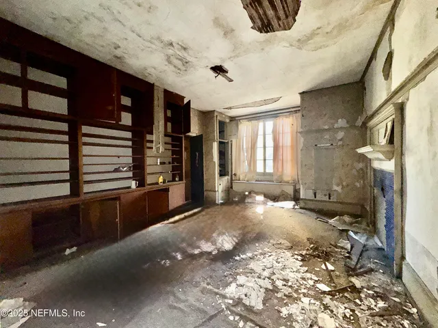 a view of room with a window and wooden floor