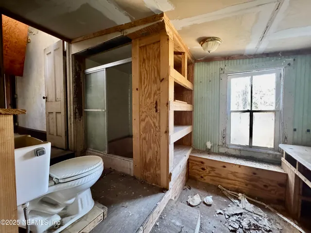 a bathroom with a toilet a sink and shower
