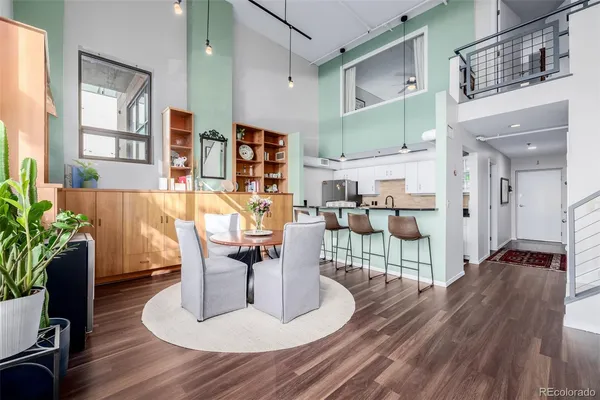 a living room with furniture a wooden floor and next to a window