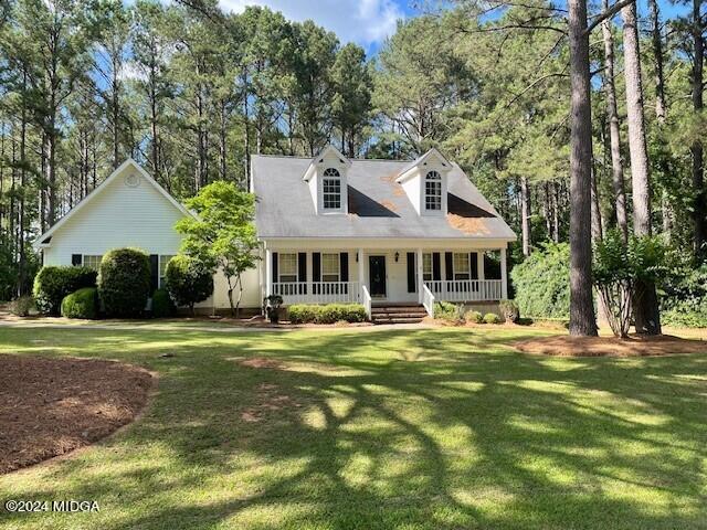 a front view of a house with a garden and trees