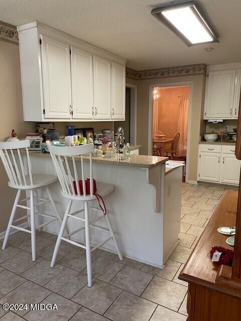 187 Bateman Lane Gray, GA 31032 - Photo 9 of 27 a kitchen with kitchen island a stove a table and chairs in it