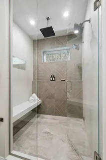 a bathroom with a shower and a sink