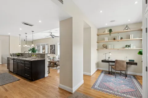 a living room with a rug and a table