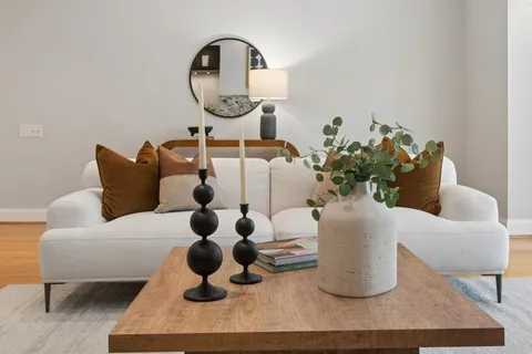 a living room with furniture and a mirror