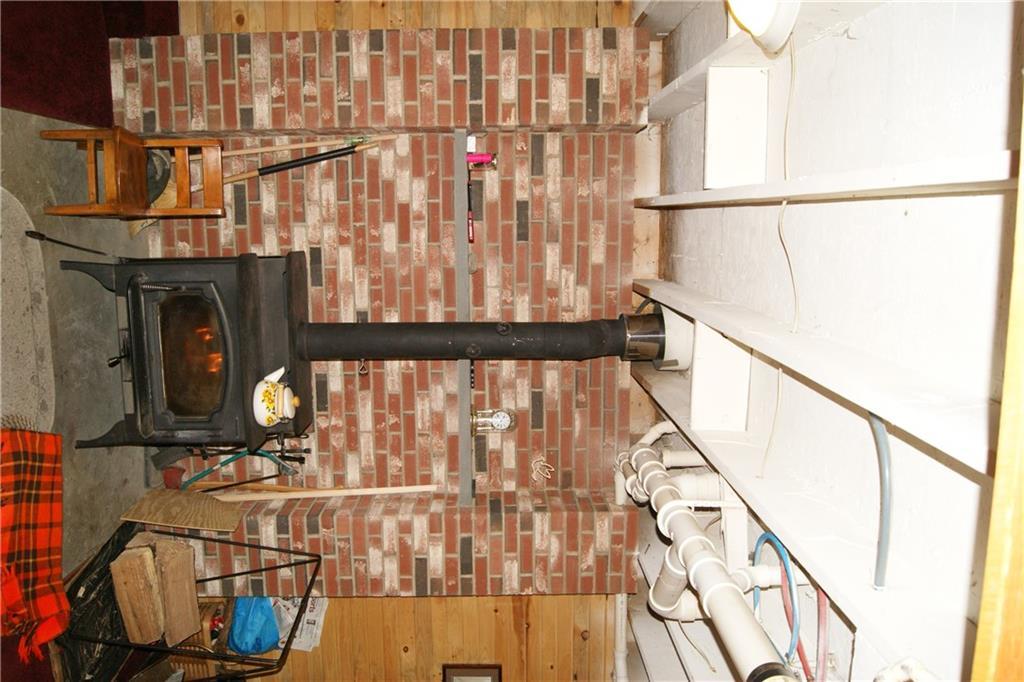140 Richmond Mills Road Fayette, ME 04349 - Photo 27 of 35 The woodstove and brick hearth in...