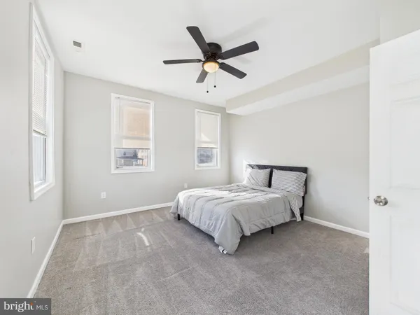 a spacious bedroom with a bed and window