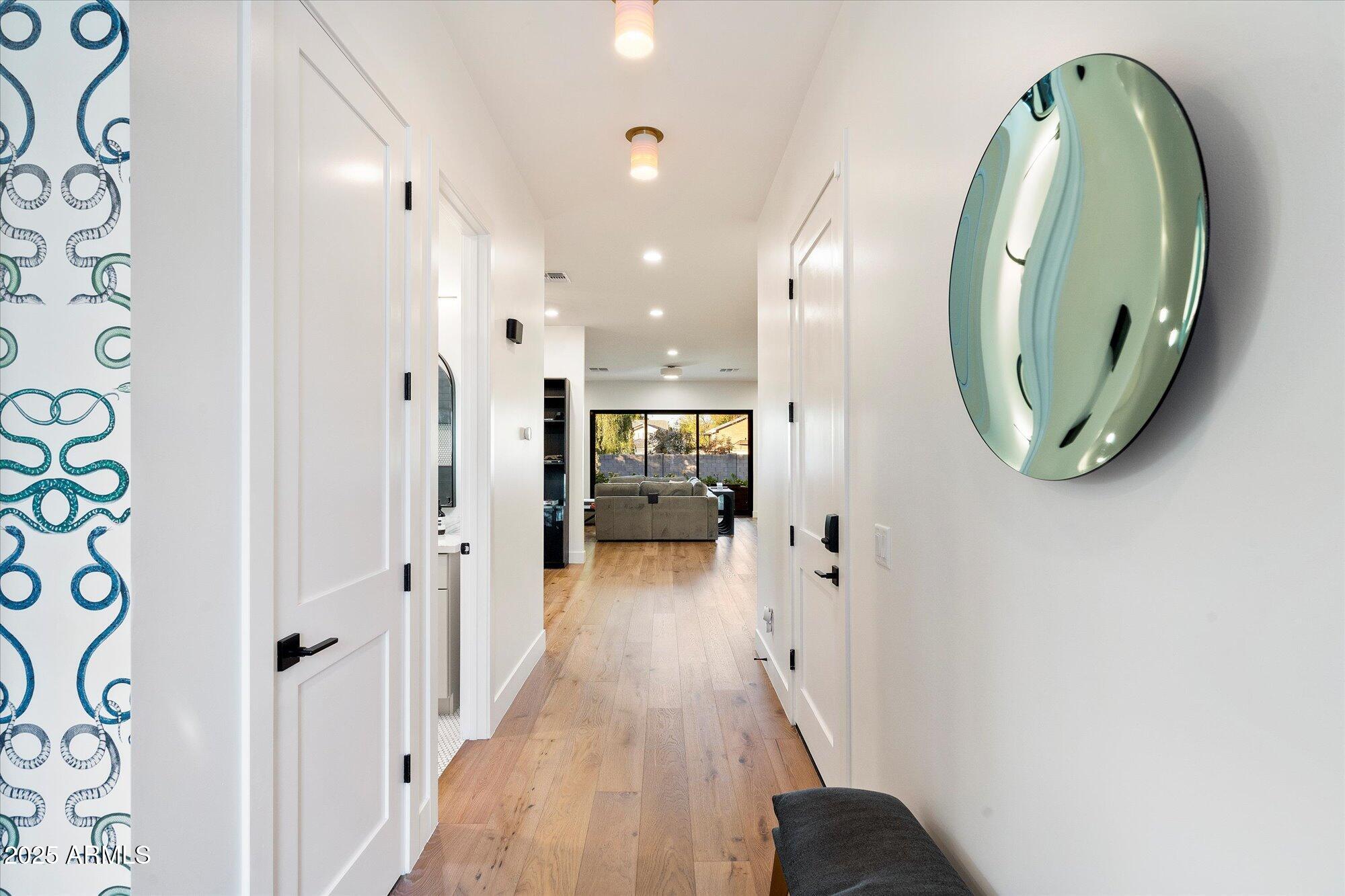 7240 North 13th Lane Phoenix, AZ 85021 - Photo 6 of 69 a view of a hallway with wooden floor and a bathroom