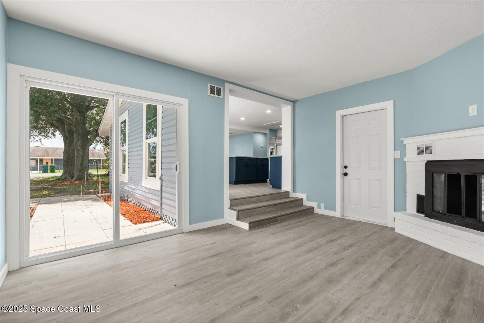 1436 Melrose Street Cocoa, FL 32922 - Photo 12 of 28 a view of an empty room with wooden floor and a window