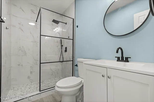 a bathroom with a toilet sink and shower