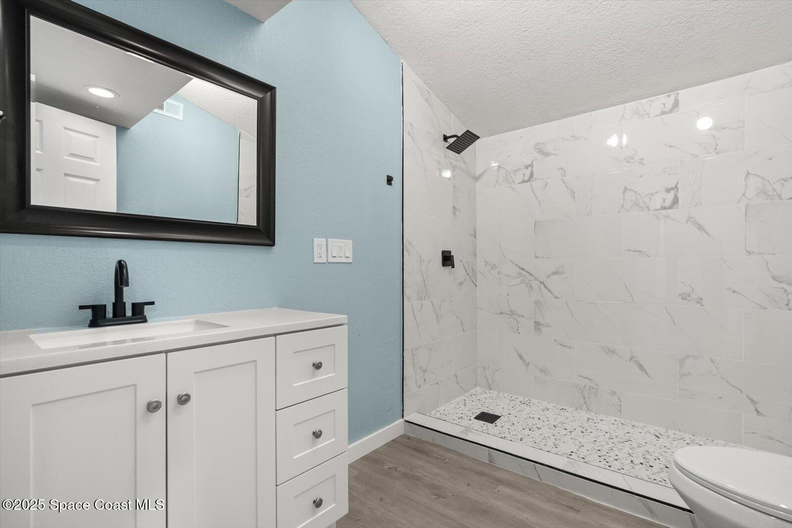 1436 Melrose Street Cocoa, FL 32922 - Photo 14 of 28 a bathroom with a shower sink and mirror