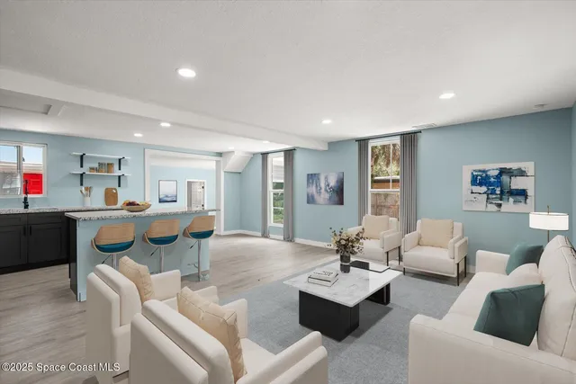 a living room with furniture kitchen view and a dining table